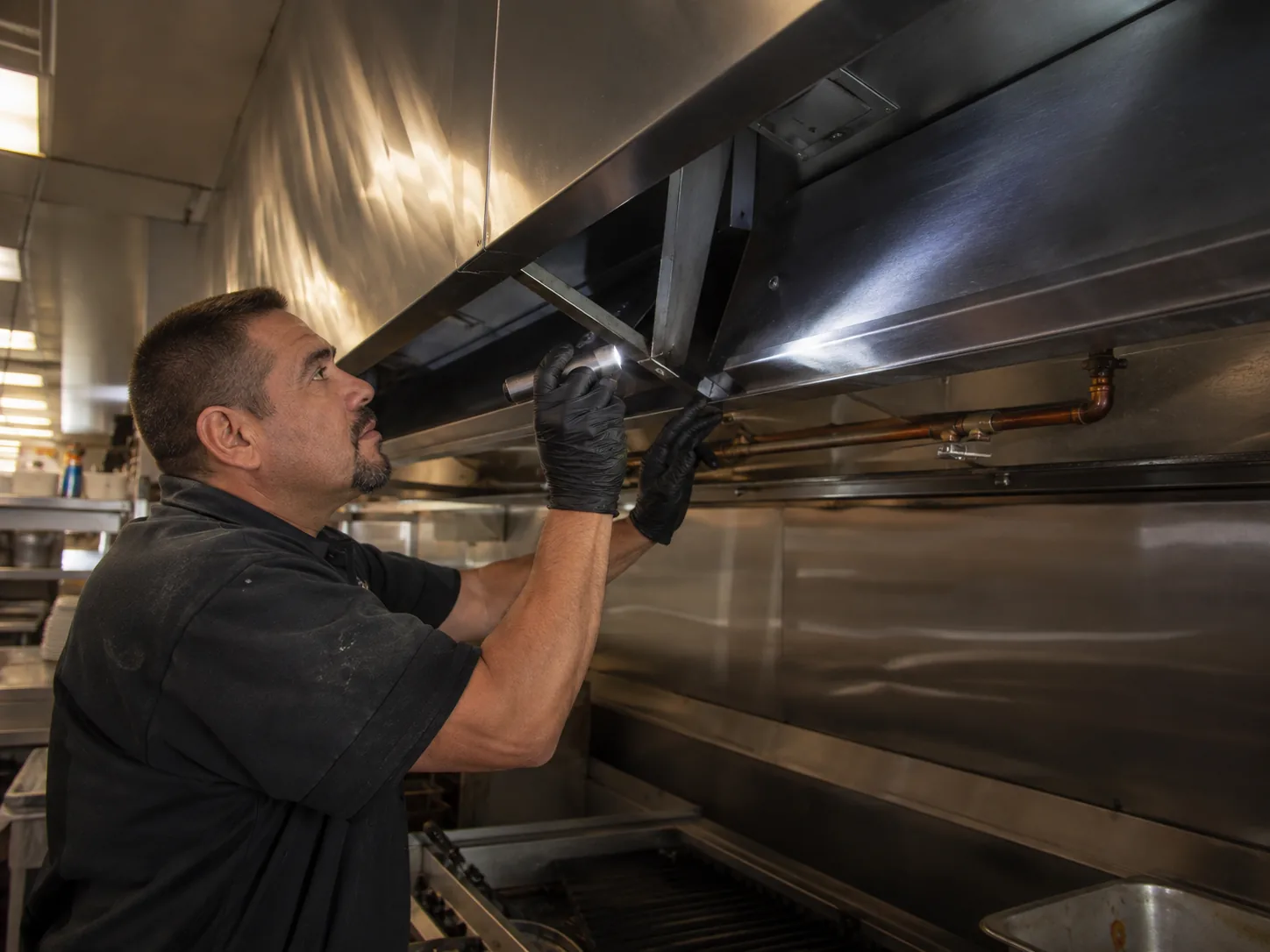 Commercial kitchen cooking equipment in a stainless-steel workspace